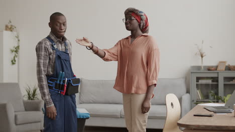 african-american woman telling carpenter what to do