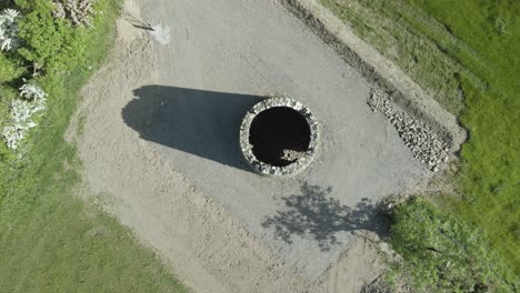 ruins of irish round tower in midlands ireland - aerial top down