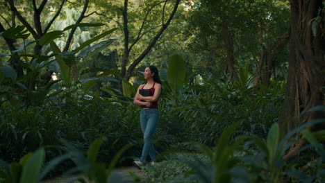 woman walking in a park with a book