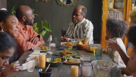 african american family chatting over holiday dinner