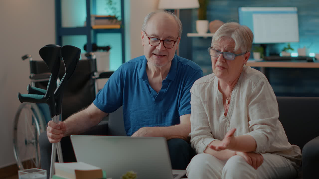 Elderly couple using laptop at home