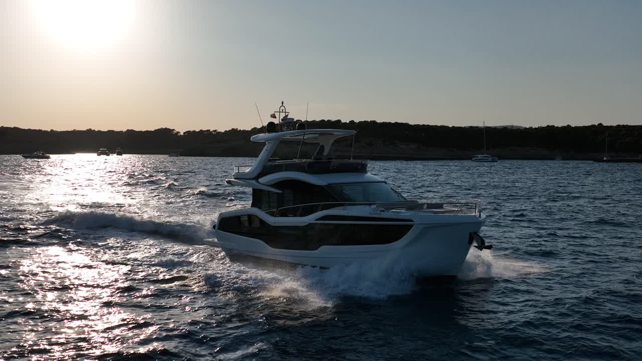 Slowmotion drone shot of luxury yacht driving during sunset in the mediterranean, mallorca