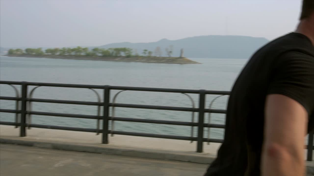 Man Skateboarding by the River
