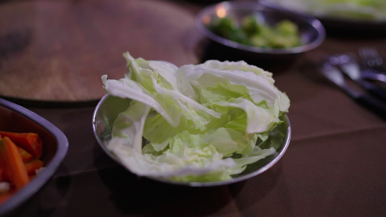 Crisp lettuce on a plate complements Bagna Cauda sauce for a fresh, flavorful bite