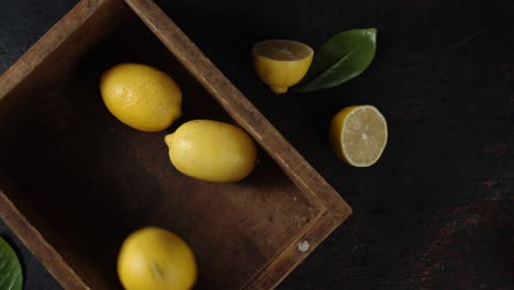 lemons fall into a wooden box.