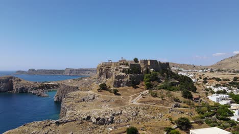 exposed acropolis of lindos in rhodes, popular greek island, aerial orbit