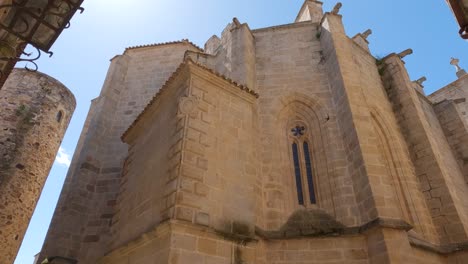 looking up at the co-cathedral of cáceres historical romanesque catholic church in the spanish town of cáceres