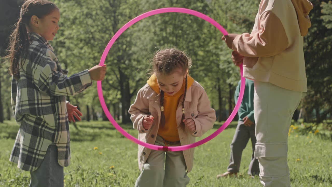Children playing hula hoop outdoors