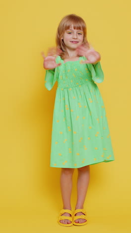 young cute school girl kid smiling friendly gesturing hello or goodbye welcoming waving hands