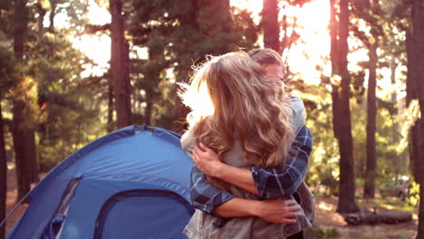 couple hugging beside their tent