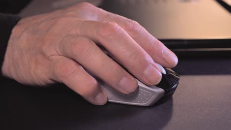 senior man's hand using a computer mouse