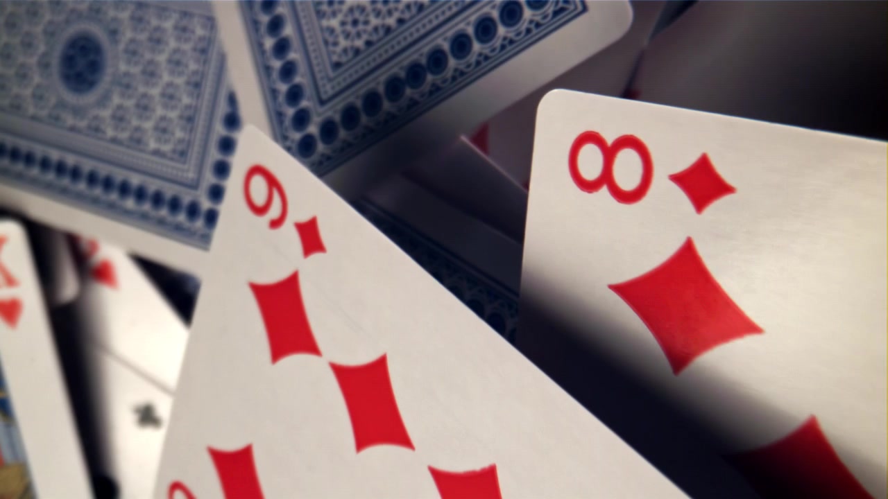 Playing Cards Falling and Scattering in a Close-up Shot