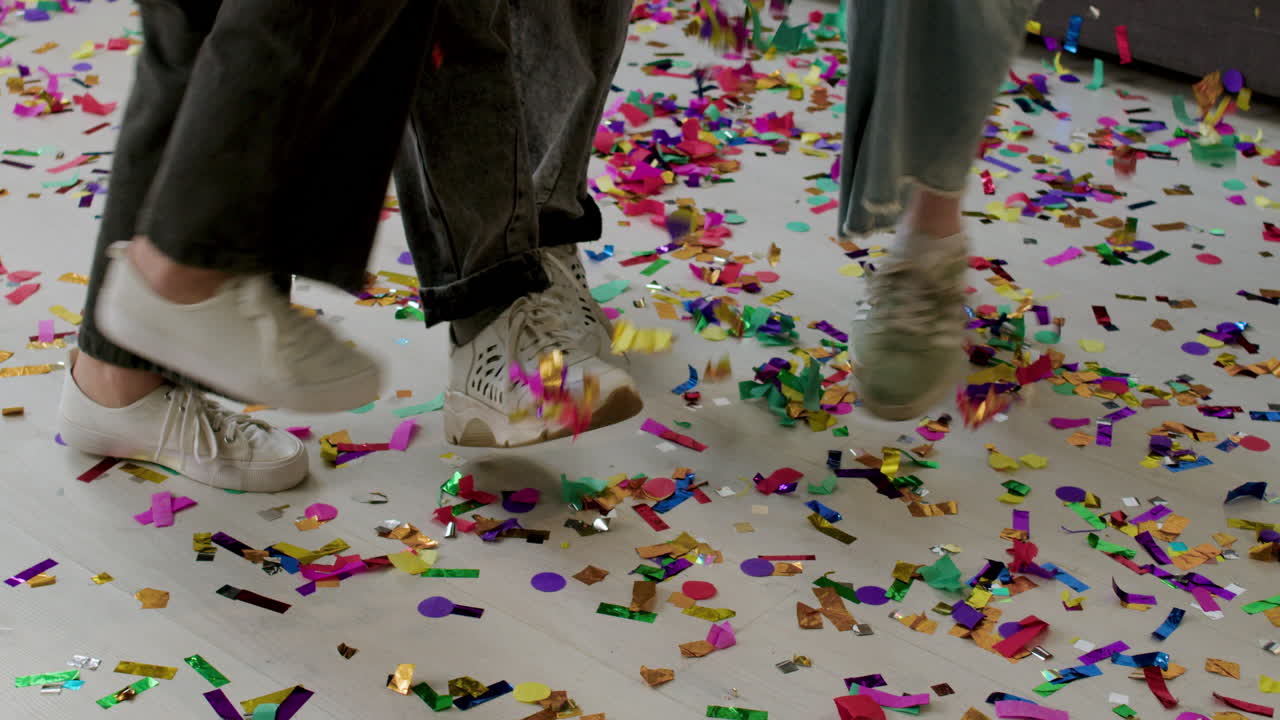 Kids' sneakers over colorful confetti