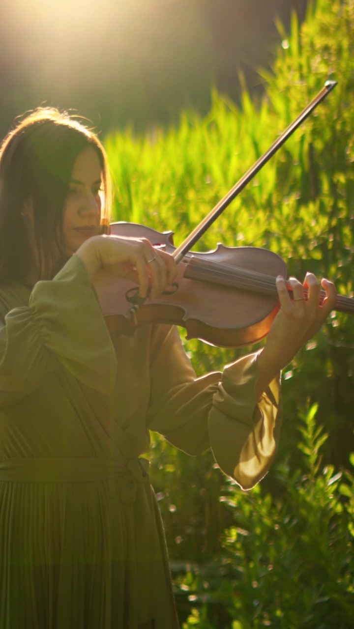 Young Woman Playing Violin by a Sunny Lake