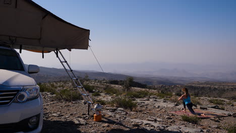 western traveler girl practicing outdoor yoga in oman, different poses in other clips available