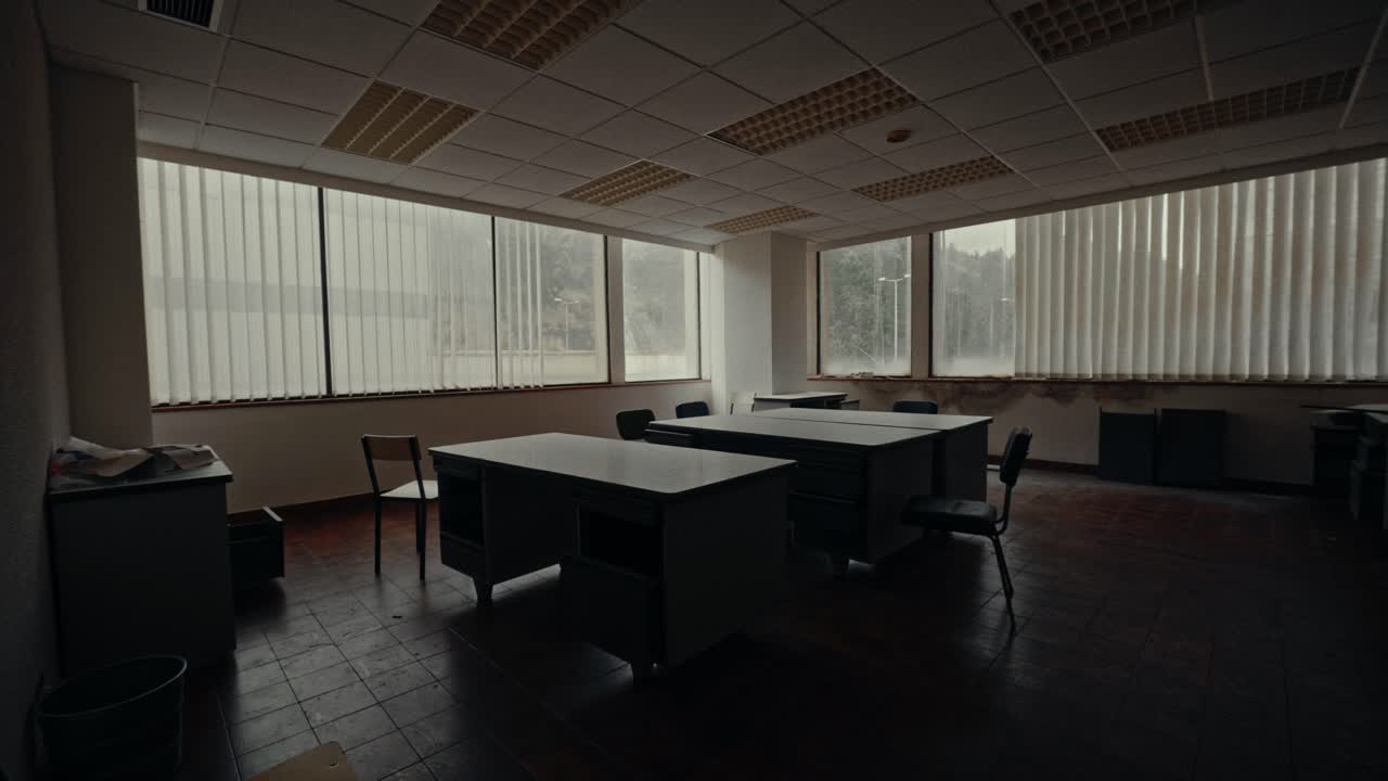 Empty Abandoned Office Room with Desks and Chairs