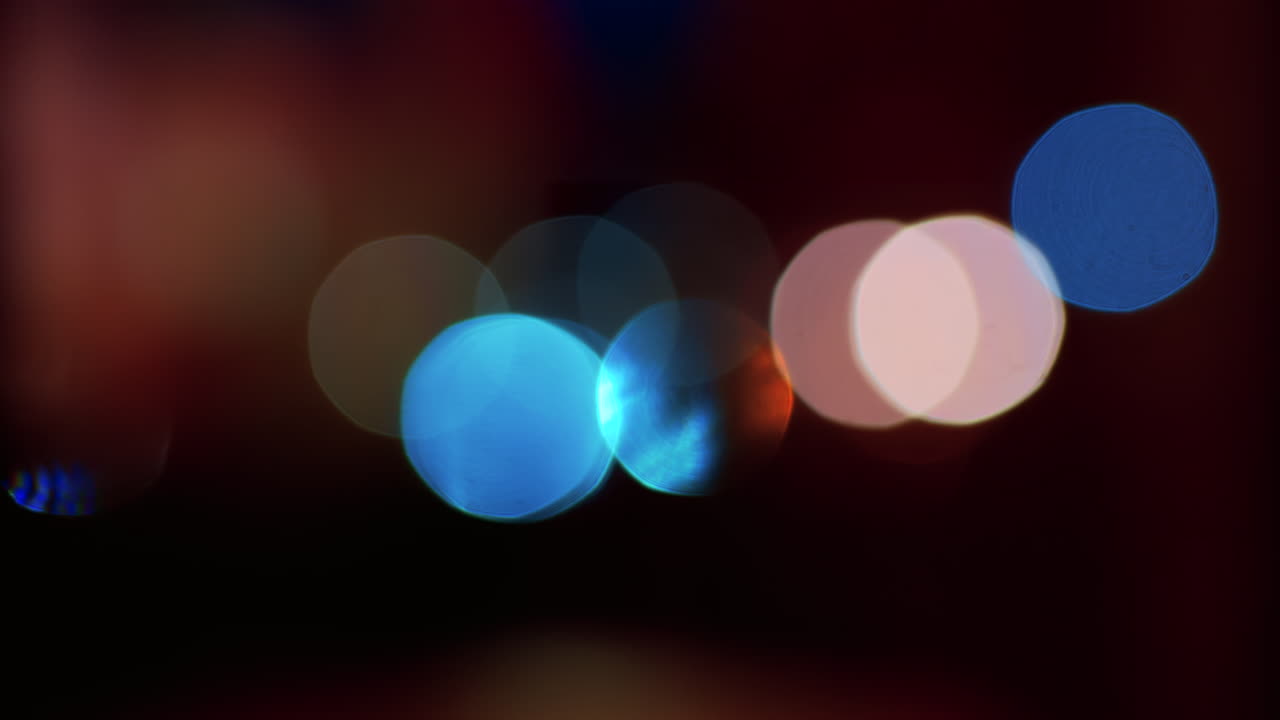 Abstract display of out-of-focus, colourful lights in a dark setting