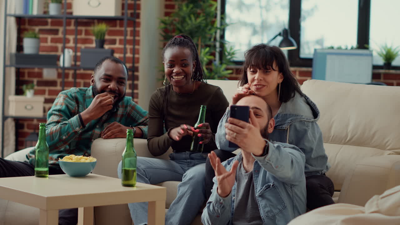 Diverse people watching funny video on smartphone