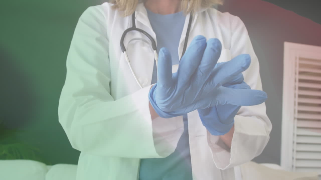 Animation of flag of italy with midsection of female doctor putting on surgical gloves