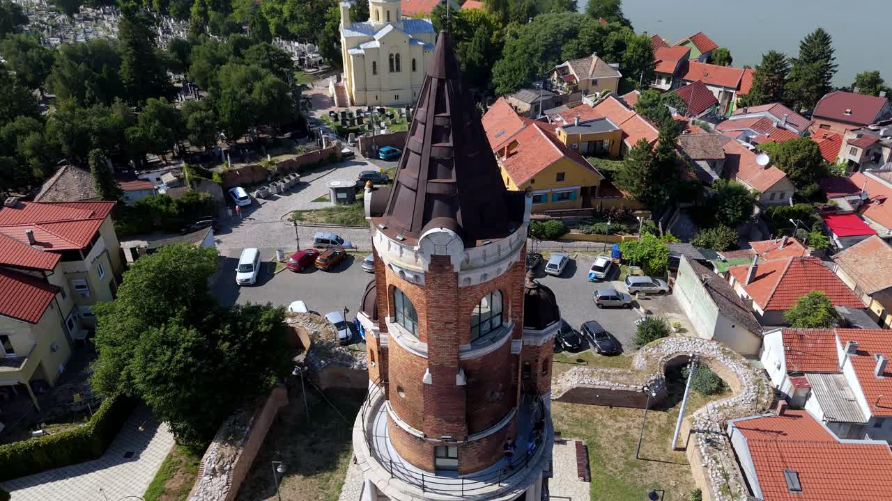 Aerial close up of Gardos Tower in Zemun, Belgrade, Serbia historic brick landmark overlooking the Danube River, surrounded by red rooftops and old town architecture