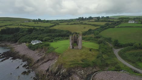 aerial view of the minard castle situated on the rocky beach of the dingle peninsula with views across the irish sea in kerry county, ireland