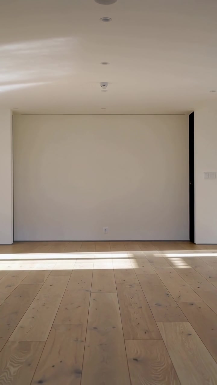 Vertical video: Showing center alcove catching sun from left window in staged room, wood floor