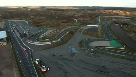 Aerial-View-Of-Car-Racing-On-Race-Circuit-Zandvoort-In-The-Netherlands---drone-shot