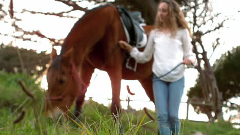 pretty woman standing next to horse