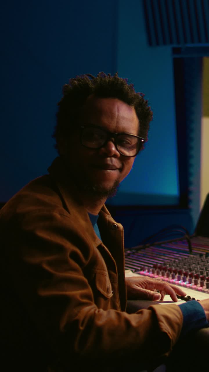 Smiling Music Producer Working in a Recording Studio