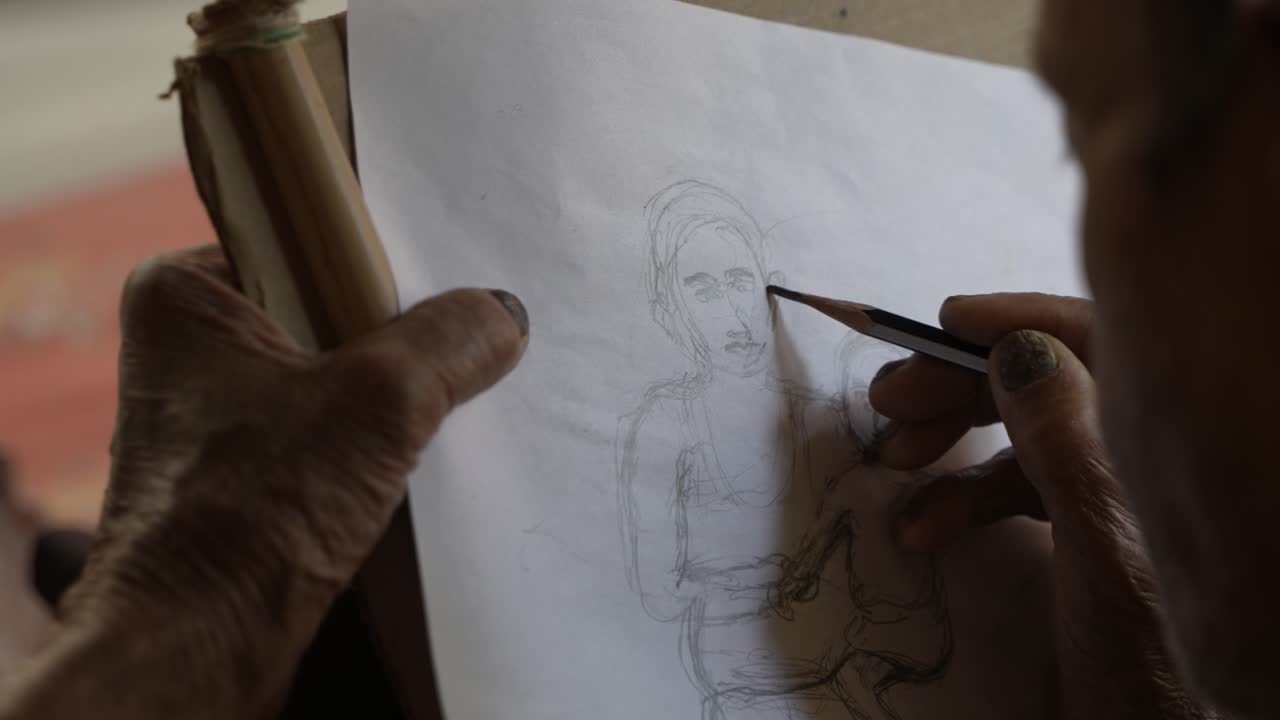 A person is drawing something with a pencil.