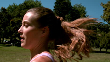 fit woman sprinting past the camera