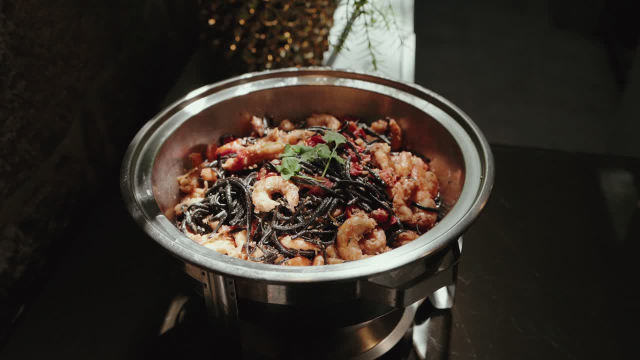 Delectable shrimp pasta with sauce shines on buffet table