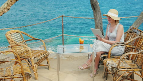 holidays on a tropical resort always connected woman talking with the tablet