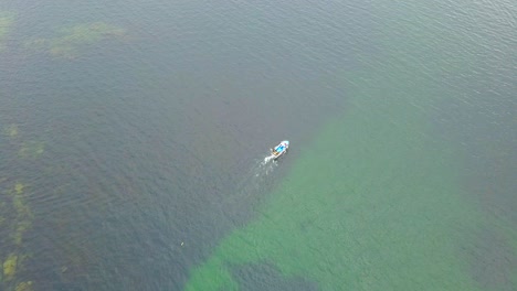 Aerial-view-of-a-fishing-boat-throwing-a