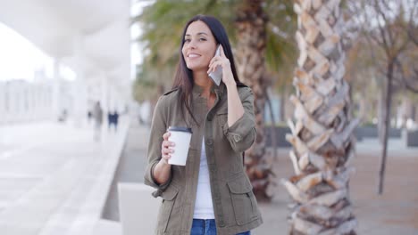 smiling trendy young woman taking a call