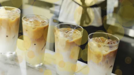 animation of falling yellow dots over ice coffee