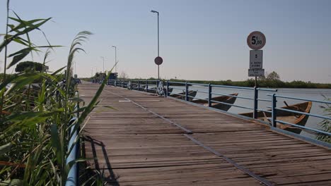 unique boat bridge car pass constructed on po di goro river delta, rural italy