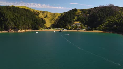 drone fly to picturesque bay with beach and small settlement near french pass, new zealand