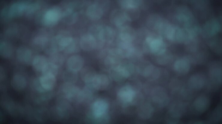 Sfondo bokeh astratto di glitter grigi scintillanti che sfumano nel nero