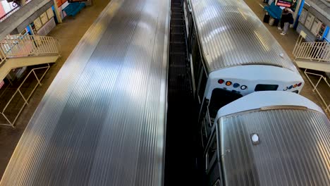 two subway trains pulling into city station overhead view