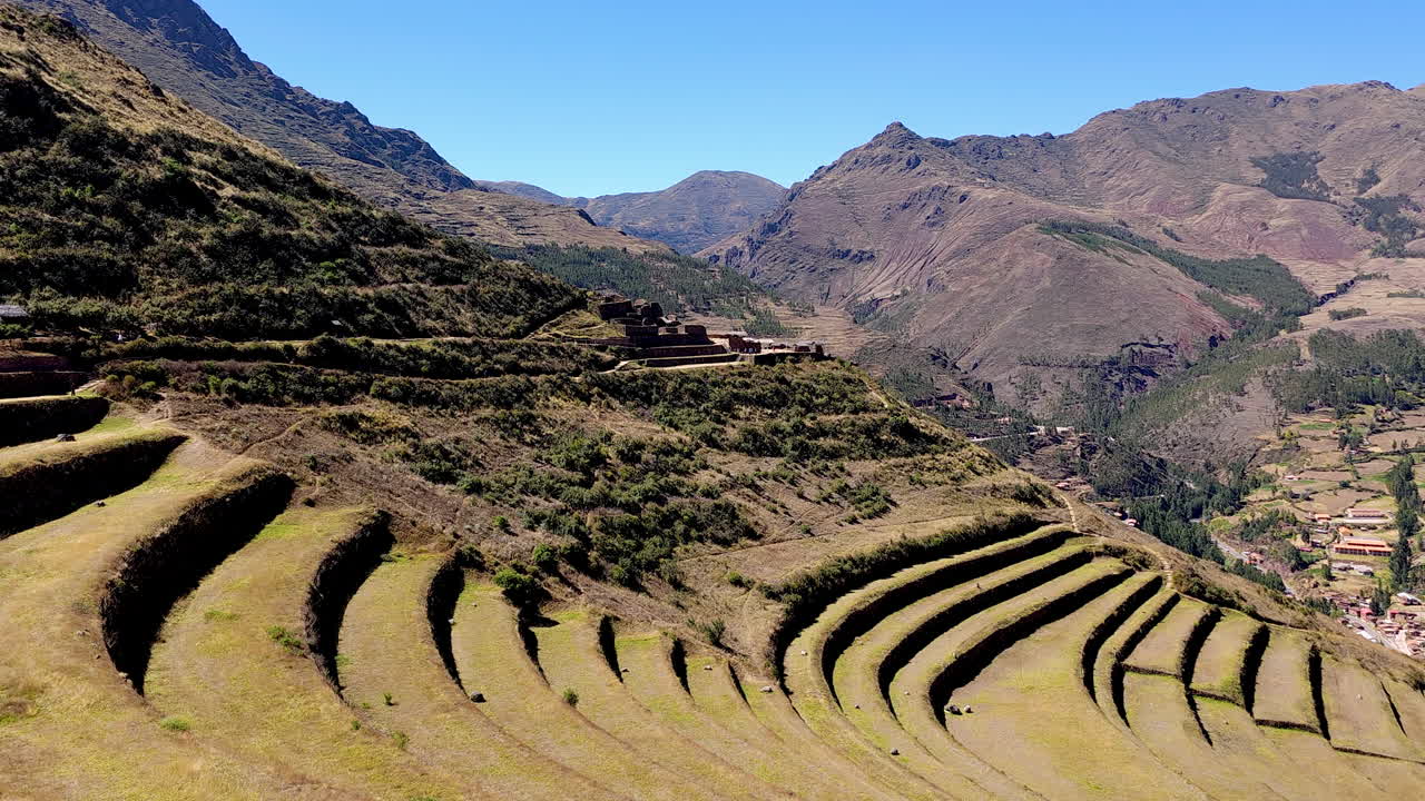 The remarkable agricultural terraces of the Pisac Archaeological Park in Peru. The footage showcases the curved, layered terraces and the stunning natural beauty of the Sacred Valley
