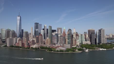 aerial view overlooking the battery park city, manhattan from hudson river, new york, usa - rising, pull back, drone shot