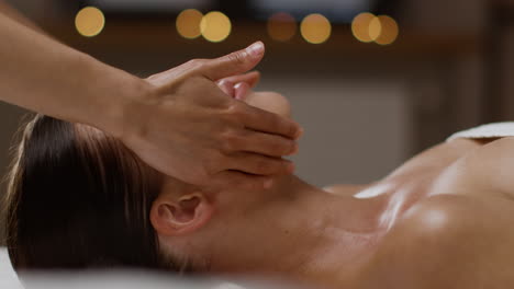 woman enjoying a relaxing facial massage at the spa