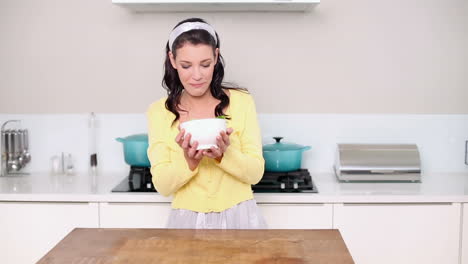 Beautiful-brunette-picking-up-a-bowl-of-salad