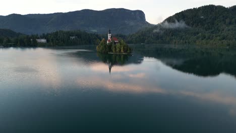 an early morning sunrise on lake bled in autumn