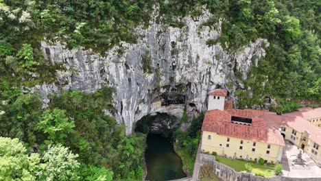 pull back drone aerial reverse reveal holy cave covadonga spain