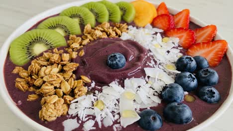 vibrant berry smoothie bowl topped with fresh fruits, granola, and coconut flakes for a nutritious breakfast delight
