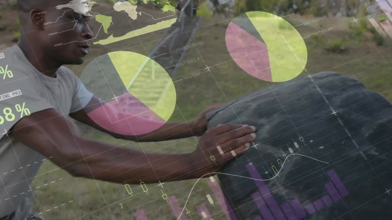 Animation of data processing over muscular man exercising with tyre