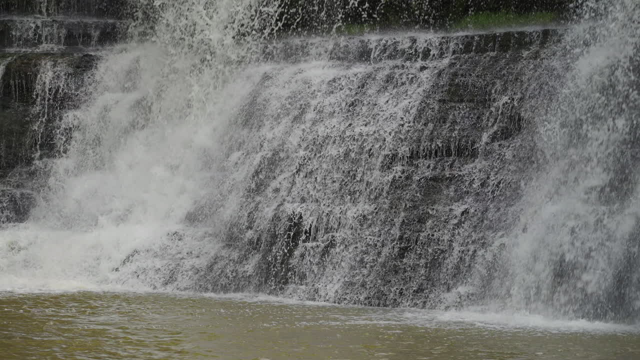 Water rushing from the top edge in slow motion at Upper Balls Falls, showing upper stream turbulence and energy