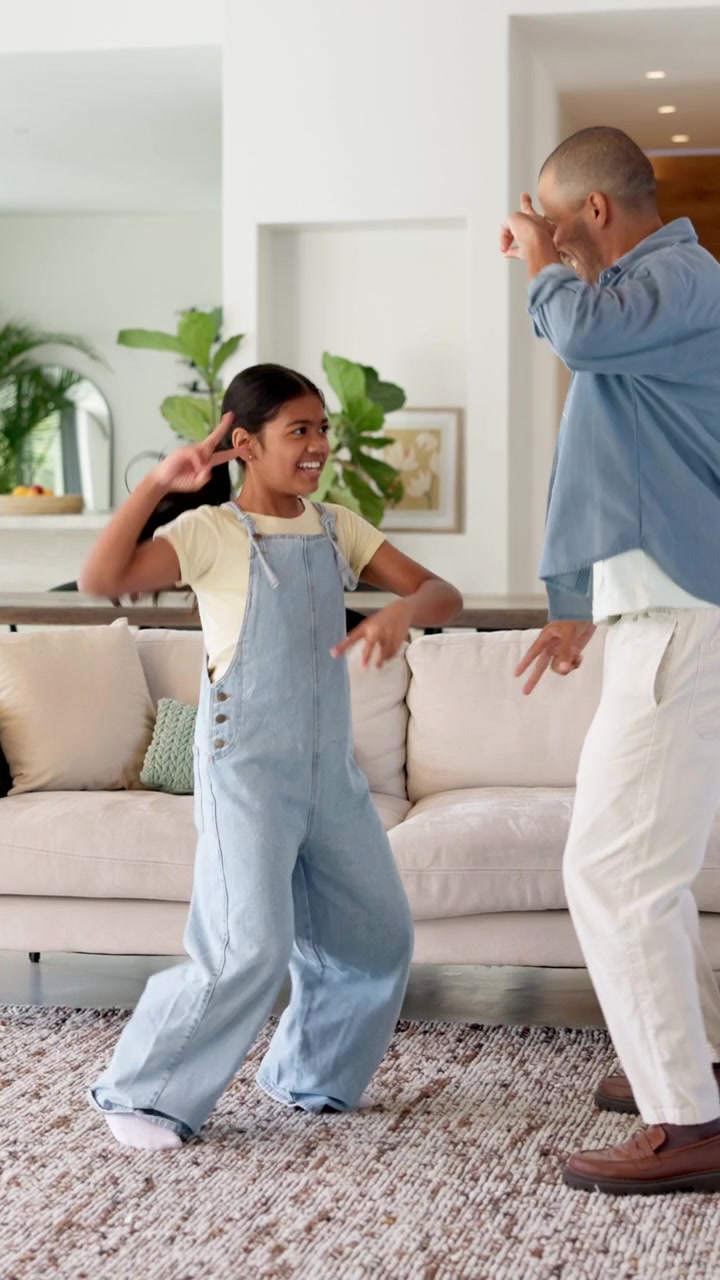 Father and Daughter Dancing Together in Living Room